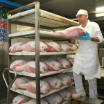 Placing re-salted ham on rack