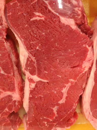 Strip steak with fat along artery/vein