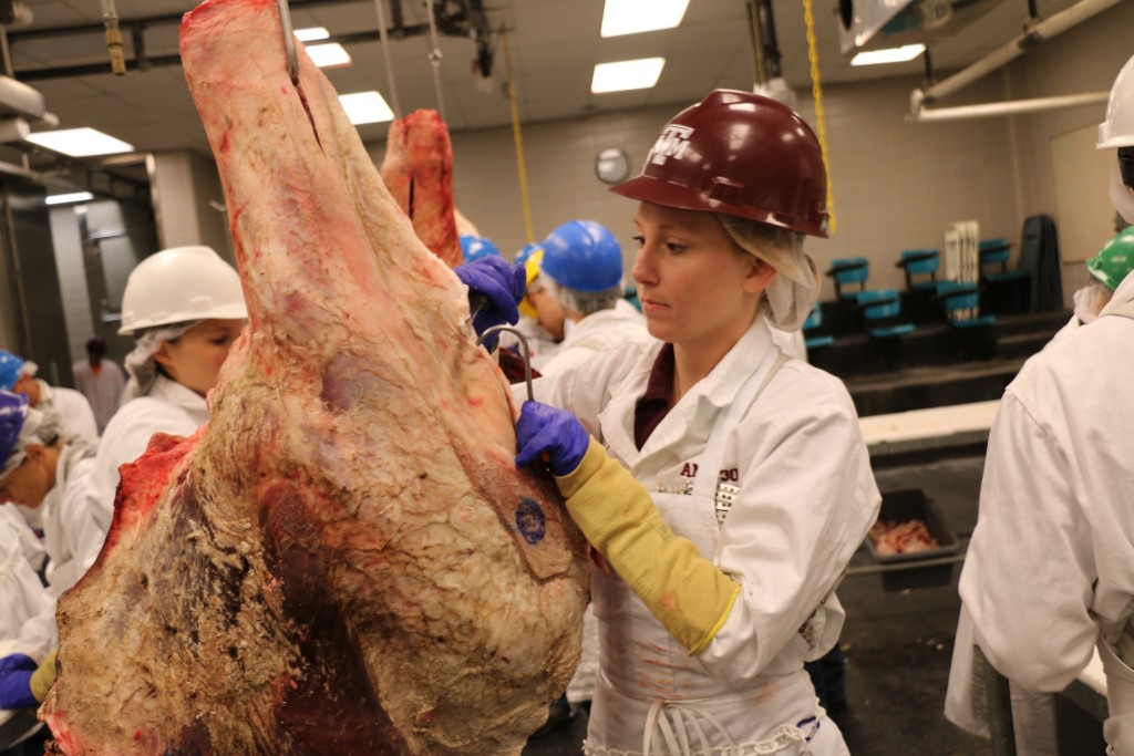 Courtney Boykin cutting beef