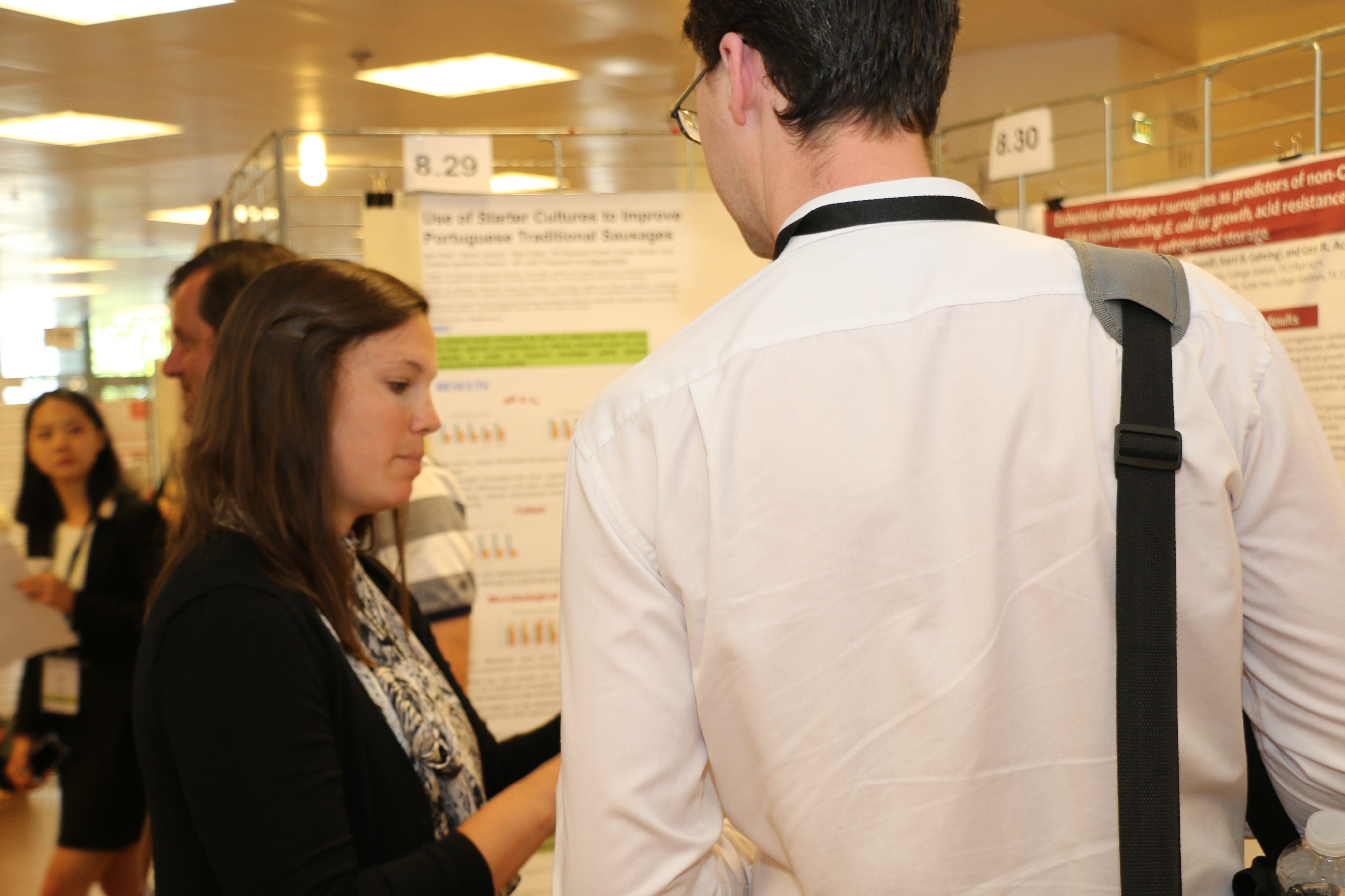 Lindsey Mehall discussing findings during poster session