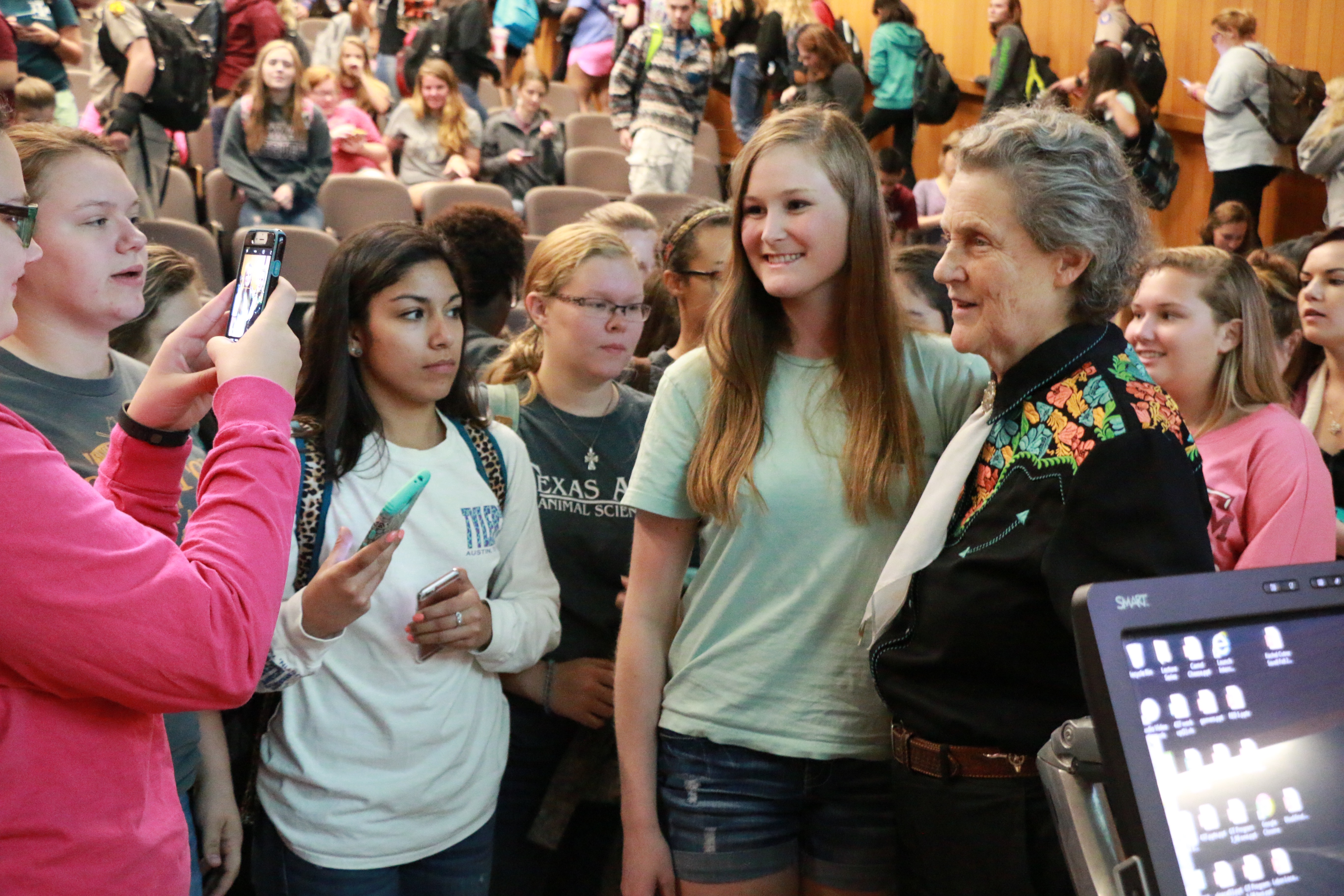 Students taking photos with Dr. Temple Grandin