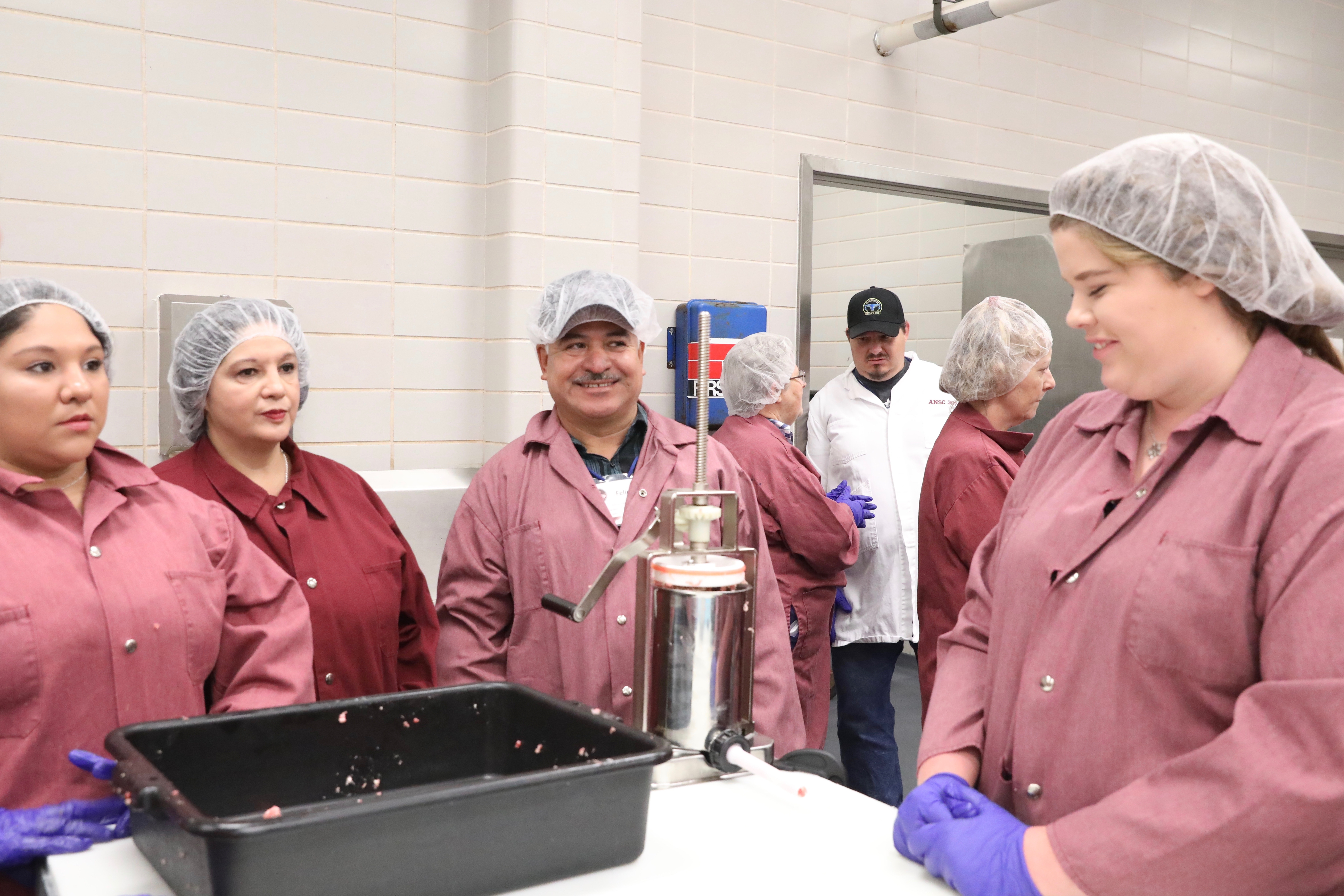 TAMP participants making fresh sausage products