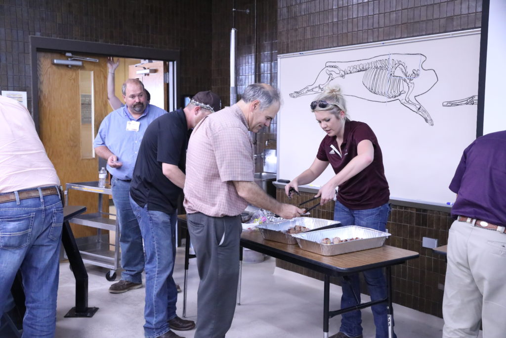 Meat Science graduate student Spencer Tindell serving finished bratwurst comparisons to participants