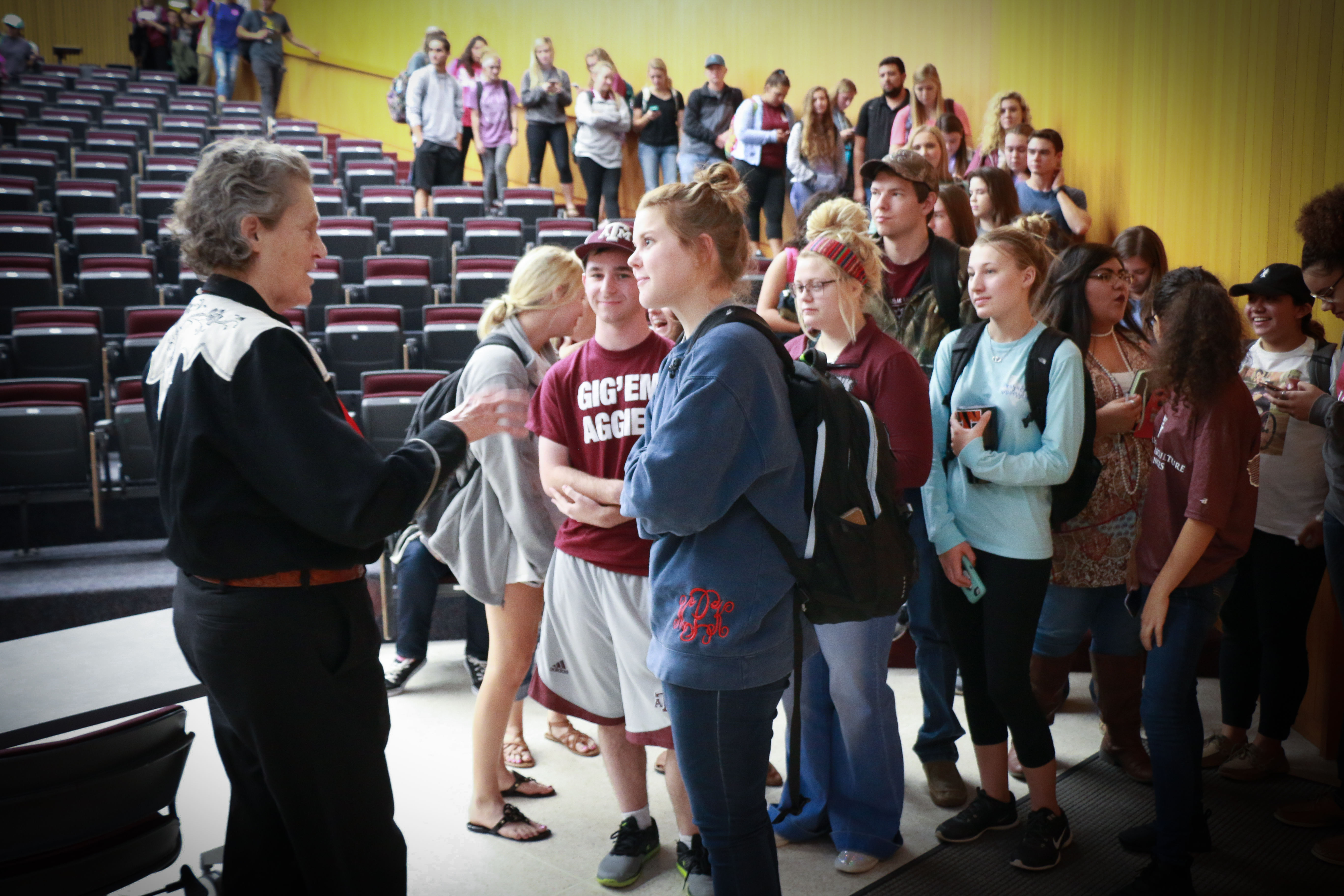 Students lining up for photographs and autographs with Dr. Grandin