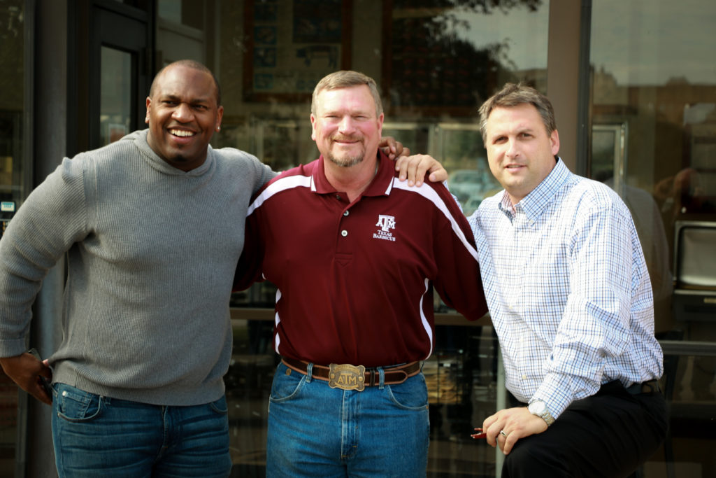 Ray Riley, center, hosts Kirk Morrison and Clay Matvick, ESPN announcers, for a tour of the Rosenthal Meat Center