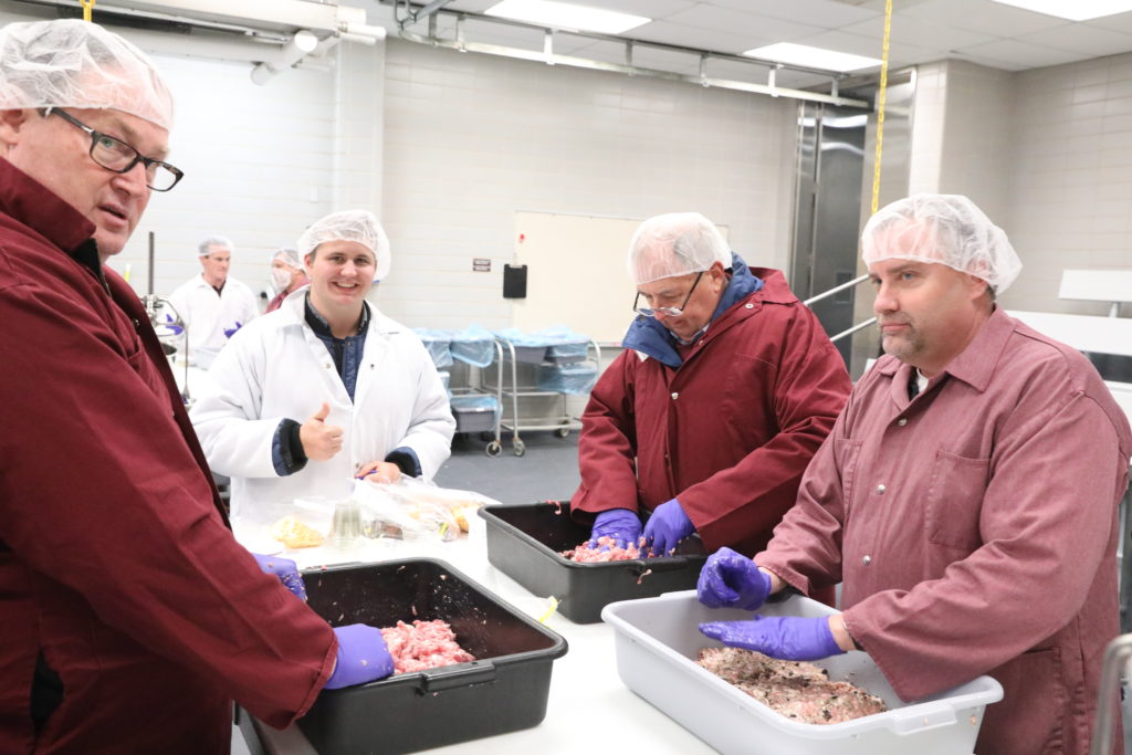 Jacob Valenta and his group seasoning and getting ready to stuff fresh sausage.