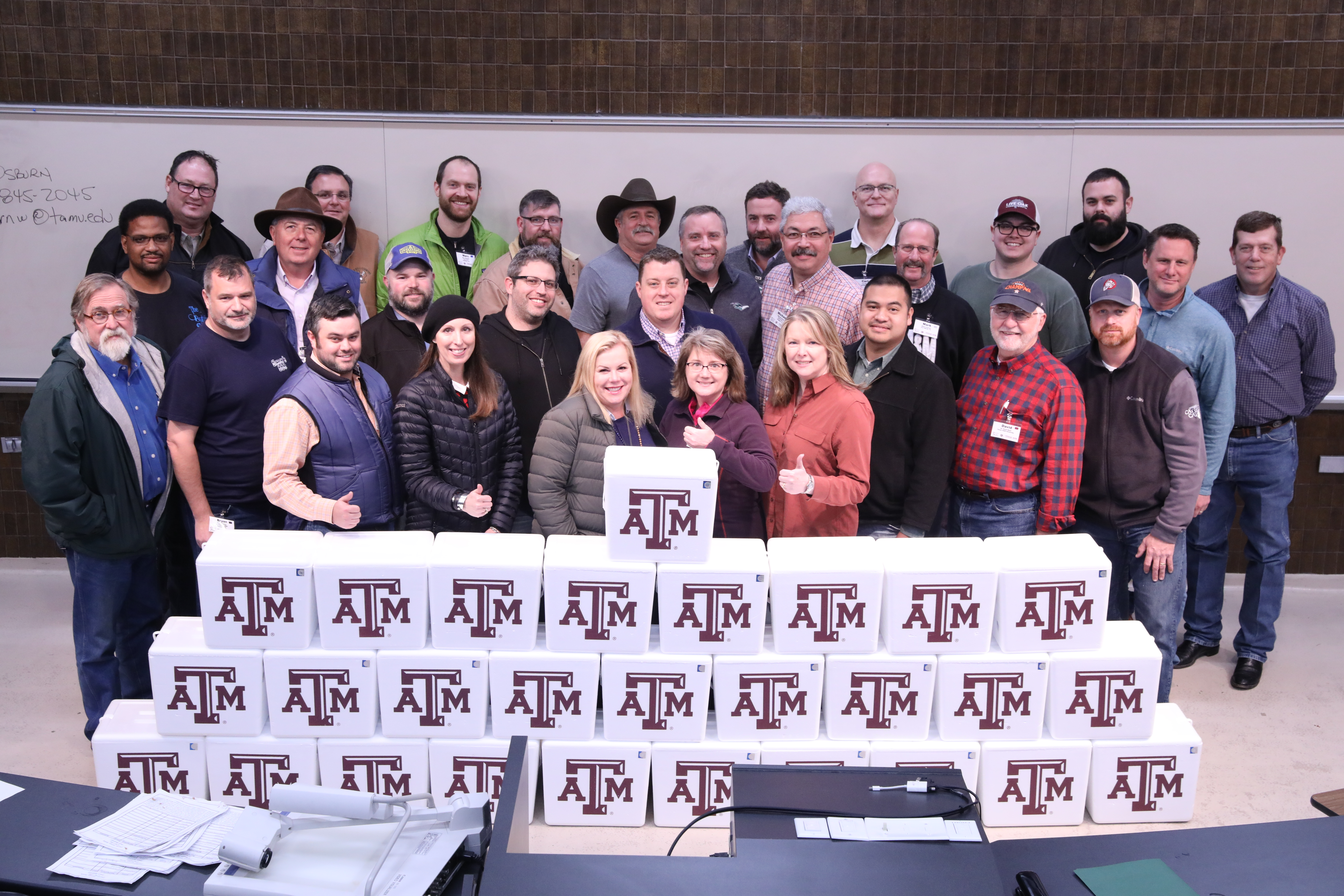 Creative Sausage Making participants with their sausage in TAMU coolers