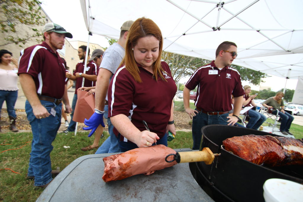 Katy Jo Nickelson working with ANSC 117, Texas Barbecue