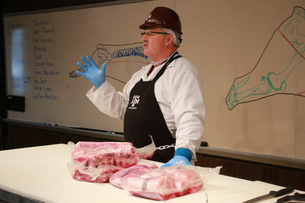 Davey Griffin cutting veal products at the Center of the Plate Workshop