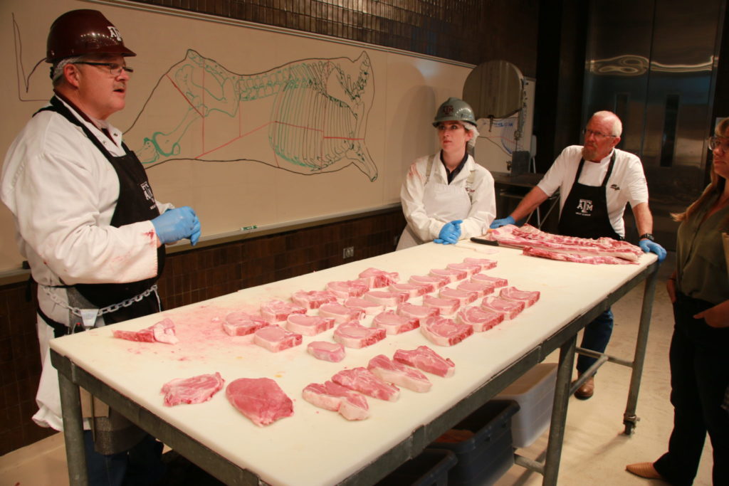 Davey Griffin, Clay Eastwood, and Jim Murray describing cuts of pork at Center of the Plate Workshop