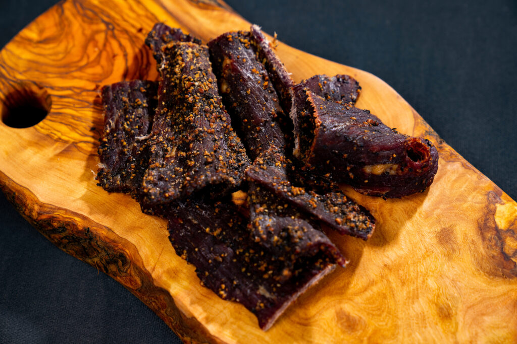 Meat jerky on cutting board.