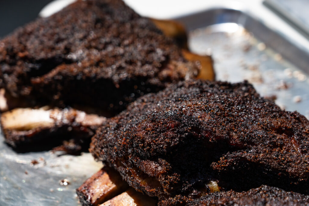 Close-up of two barbecued cuts of meat.