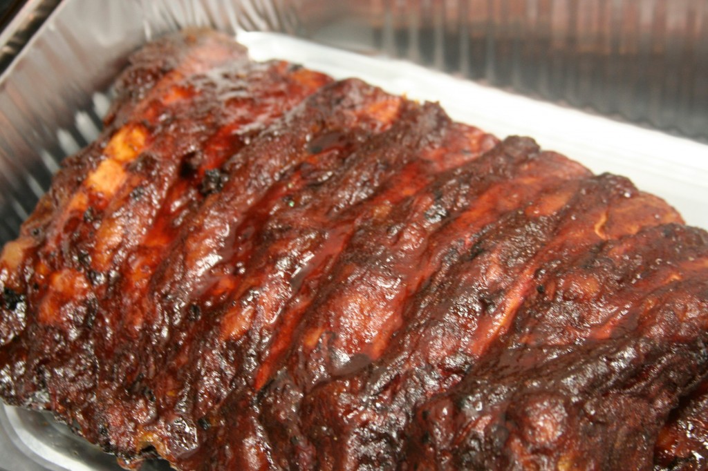 Close up of ribs inside a metal container. 