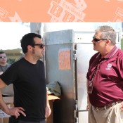 Aaron Franklin and Davey Griffin both talking together under a tarp.